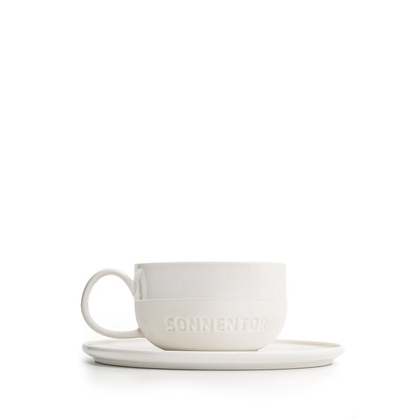 The photo shows a white SONNENTOR porcelain melange cup with saucer for a quantity of 150 ml!
